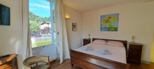 a bedroom with a bed and a large window at Bed and Breakfast Via Rinaldi in Madonna del Sasso