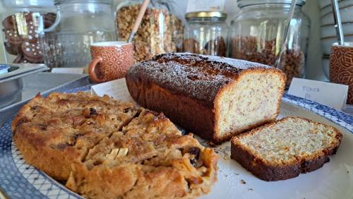 a plate of bread and cakes on a table at Bed and Breakfast Via Rinaldi in Madonna del Sasso
