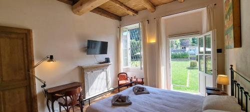a bedroom with a bed and a large window at Bed and Breakfast Via Rinaldi in Madonna del Sasso