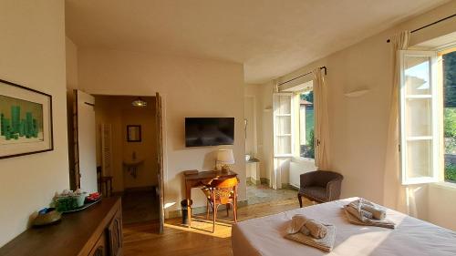 a bedroom with a bed and a desk and window at Bed and Breakfast Via Rinaldi in Madonna del Sasso