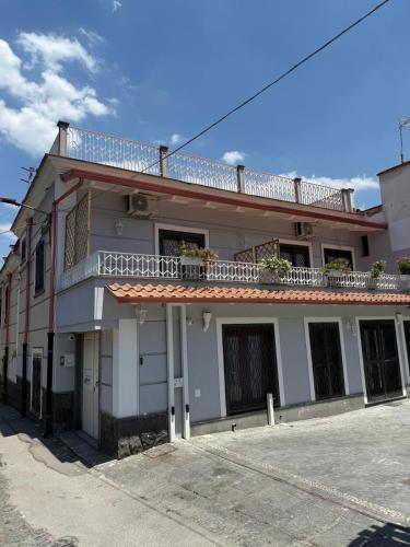 a white building with a balcony on top of it at Casa Midea in Terzigno