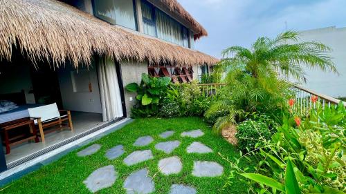 a house with a grass yard in front of it at Private 4 bedrooom Nongnia Beach Villas in Tân Thành (1)