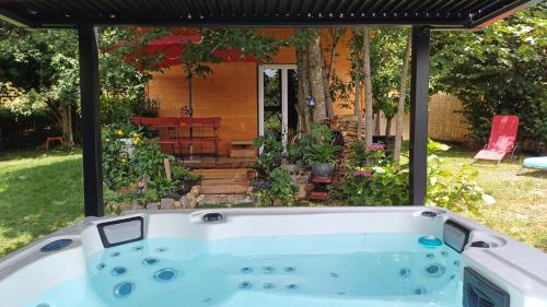 a bath tub in front of a house at Le Jardin D' Épicure in Oderen