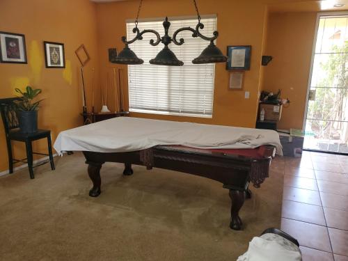 a room with a bed with a sheet on it at Galaxy House in Sun City