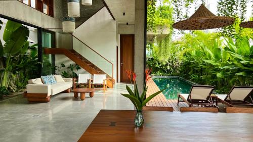 a living room with a couch and chairs and a pool at Private 4 bedrooom Nongnia Beach Villas in Tân Thành (1)