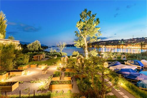 an aerial view of a resort with a lake at Strandhotel Schmerikon in Schmerikon