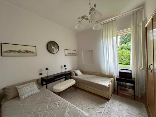 a bedroom with a bed and a couch and a window at villa Landana in Intra
