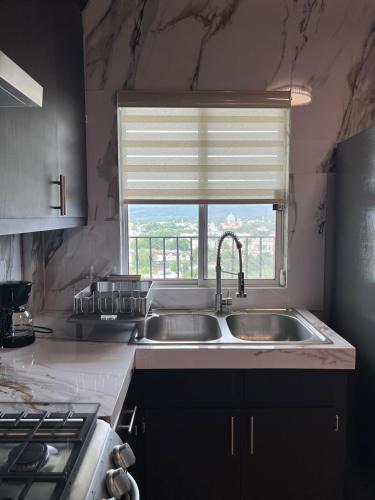 a kitchen with a sink and a window at Estancia Santa Cruz in Allende