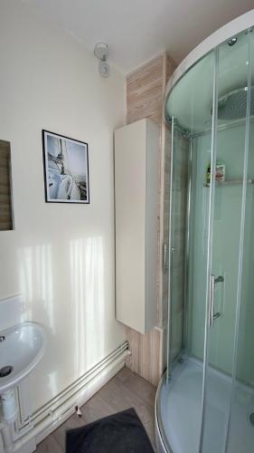 a bathroom with a glass shower and a sink at Ptit Somme en Baie in Saint-Valéry-sur-Somme