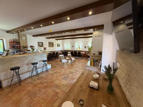 a large room with a bar and tables and chairs at Penzion Šejby in Horní Stropnice