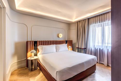 a hotel room with a bed and a window at Dimora Coppelle in Rome