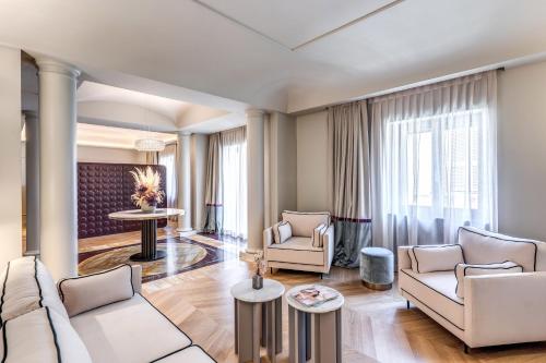 a living room with a couch and chairs and a table at Dimora Coppelle in Rome