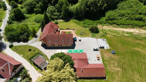 an overhead view of a large brick house with a yard at Penzion Šejby in Horní Stropnice