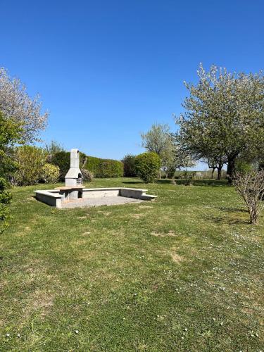 a park with a monument in the middle of a field at La Roselière du Der in Giffaumont