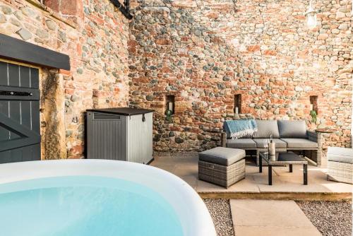 a hot tub in a room with a brick wall at 2 Bed in Dalston oc-g32205 in Dalston