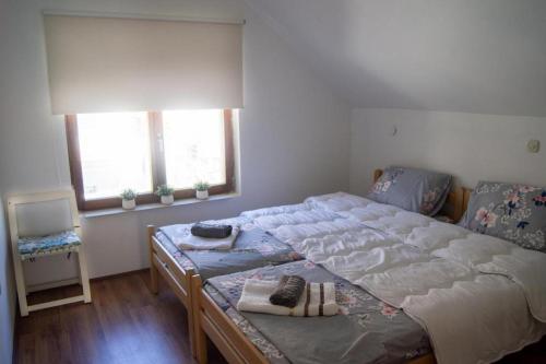 a bedroom with a large bed with shoes on it at Villa Lakeview Paradise in Peštani