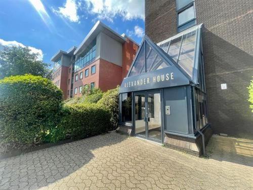 a large building with a building with ansicsnsicsnsicsnsicsnsicsnsicsnsicsnsics at Trendy Apt in the Heart of MCR in Manchester