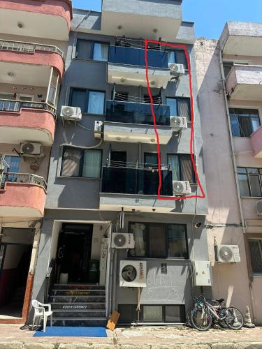 an apartment building with a red cord hanging from it at Nr1 Pansiyon in Canakkale
