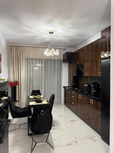a kitchen and dining room with a table and chairs at Future Apartments in Giroc