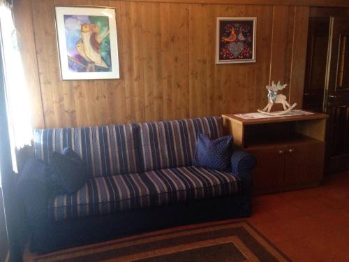 a living room with a couch and a table at Villa San Martino in San Martino di Castrozza