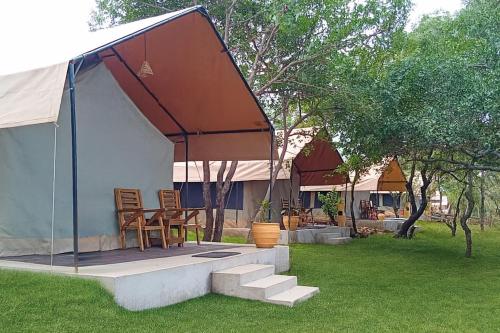 a tent with a table and chairs in a yard at Africa Safari Manyara Escarpment in Mto wa Mbu