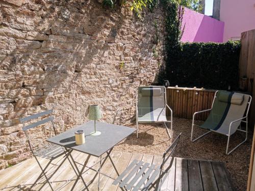 d'une terrasse avec 2 chaises, une table et 2 chaises. dans l'établissement Les studios de la gare linge café thé inclus wifi, à Vannes