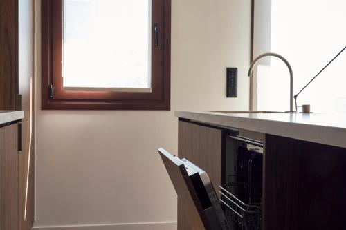 a kitchen with a sink and a counter at Ikima Living in Piraeus