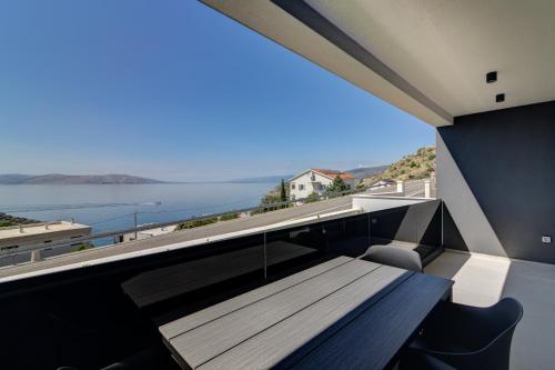 a view of the ocean from the balcony of a house at Apartmani Olimp2 in Sveti Juraj