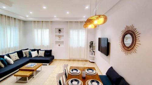 a living room with a couch and a table at Dar Houta Hammamet Mrezga in Nabeul