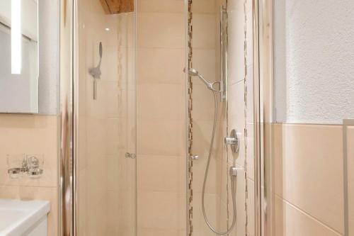 a shower with a glass door in a bathroom at Müllerjörgenhof in Gutach