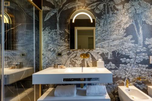 a bathroom with a sink and a mirror at Ambasciatori Suite Hotel in Sottomarina