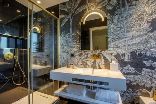 a bathroom with a sink and a mirror at Ambasciatori Suite Hotel in Sottomarina