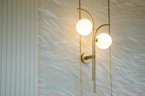 a pair of lights hanging on a wall at Ambasciatori Suite Hotel in Sottomarina