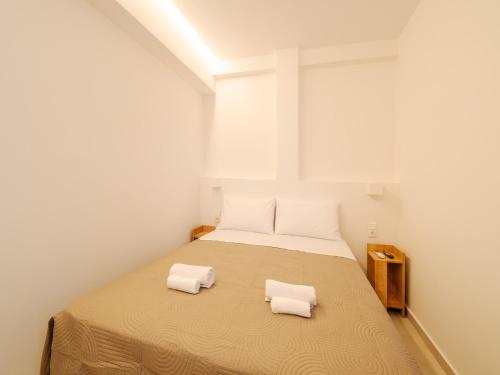 a bedroom with a bed with two towels on it at Terra Residence in Ágios Rókkos