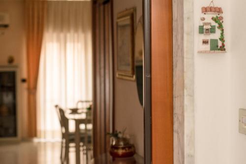 a refrigerator in a living room with a table at La Casa Di Rosa in Matera