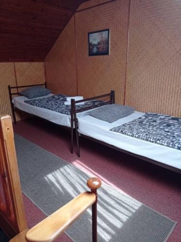 two twin beds in a room with at Zakarpatska Kolyba in Odesa
