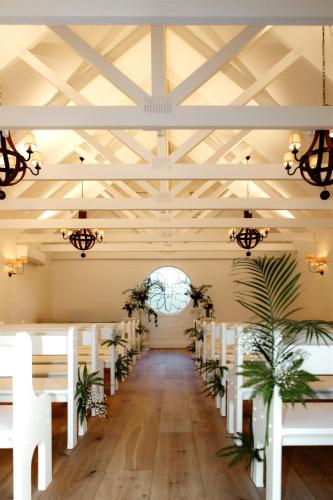 a room with tables and chairs and a ceiling at Beach Haven at Aanuka Beach Resort Diggers Beach in Coffs Harbour