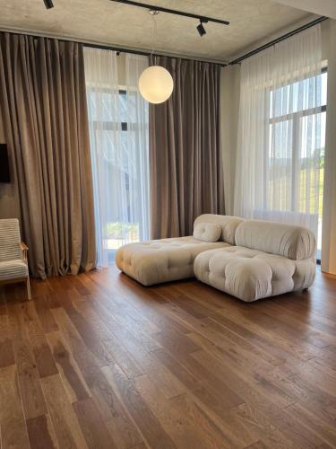 a large living room with a large bean bag couch at Котеджі Грань in Bukovel