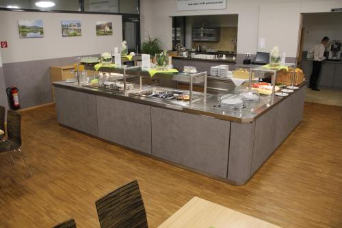 a buffet line in a restaurant with food on display at Campus Bad Kissingen in Bad Kissingen