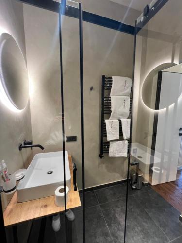 a bathroom with a sink and a shower at Котеджі Грань in Bukovel