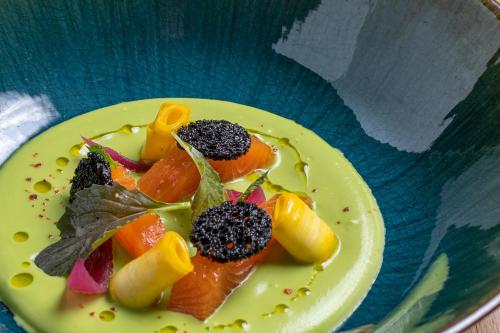 a plate of food with fruit on a table at Le Domaine Du Colombier in Malataverne