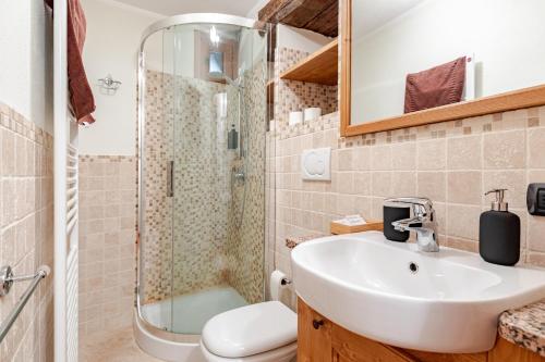 a bathroom with a sink and a shower at Chalet Après-ski Courmayeur center in Courmayeur