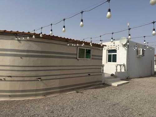 a garage with lights on the side of a house at Amg in Sabkhah