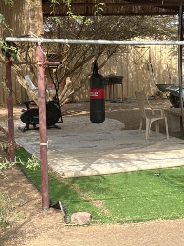 a black bottle hanging from a pole in a yard at Amg in Sabkhah