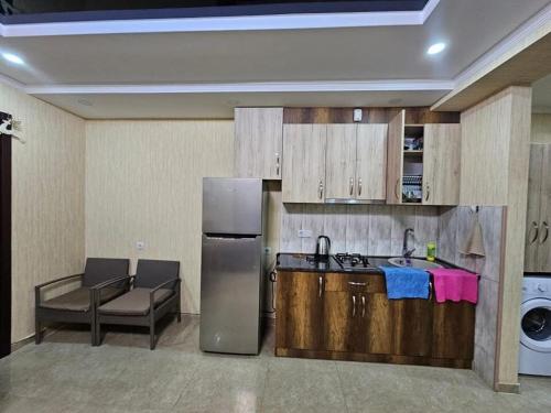 eine Küche mit einem Kühlschrank und einem Sofa in einem Zimmer in der Unterkunft Horizont Apartment 17 in Bakuriani