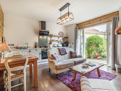 a living room with a couch and a table at Horseshoes House in Watton