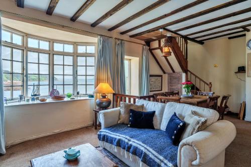 a living room with a couch and a table at Finest Retreats - April Cottage in Cawsand