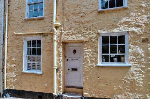 a building with a white door and windows at Finest Retreats - April Cottage in Cawsand