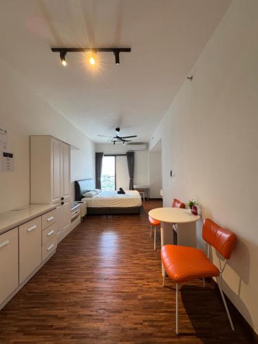 a kitchen and living room with a bed and a table at K Avenue High Floor Studio Balcony with Sunrise View in Kota Kinabalu