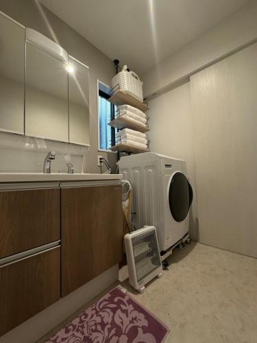 a kitchen with a sink and a microwave at Near the station, no fee parking, 1 limited group, quiet residence, 2 floors 3LDK, 18 minutes from Nippori, Akihabara, Ueno, Tokyo 30 minutes in Tokyo